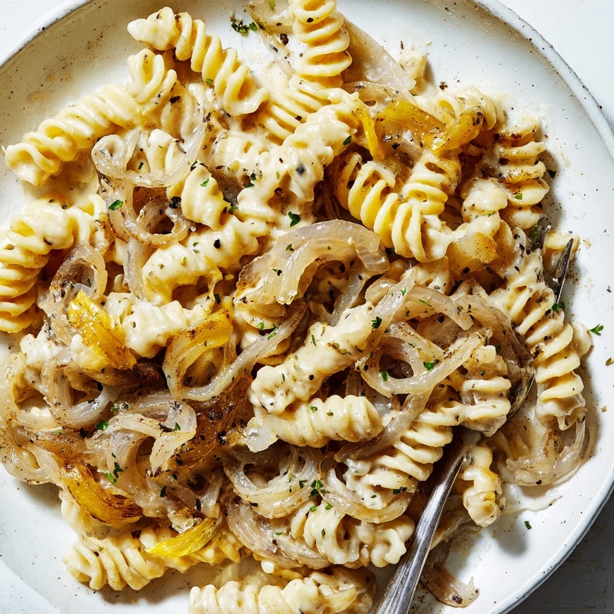 Golden One-Pot French Onion Pasta, bubbling in the pot, ready to serve with parsley.