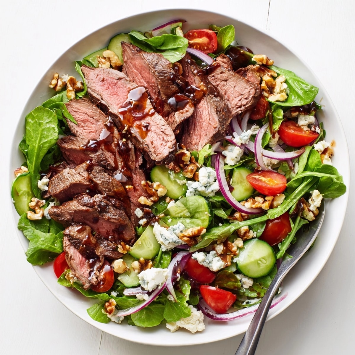 Delectable Balsamic Steak Gorgonzola Salad, ready to eat with crusty bread and red wine.