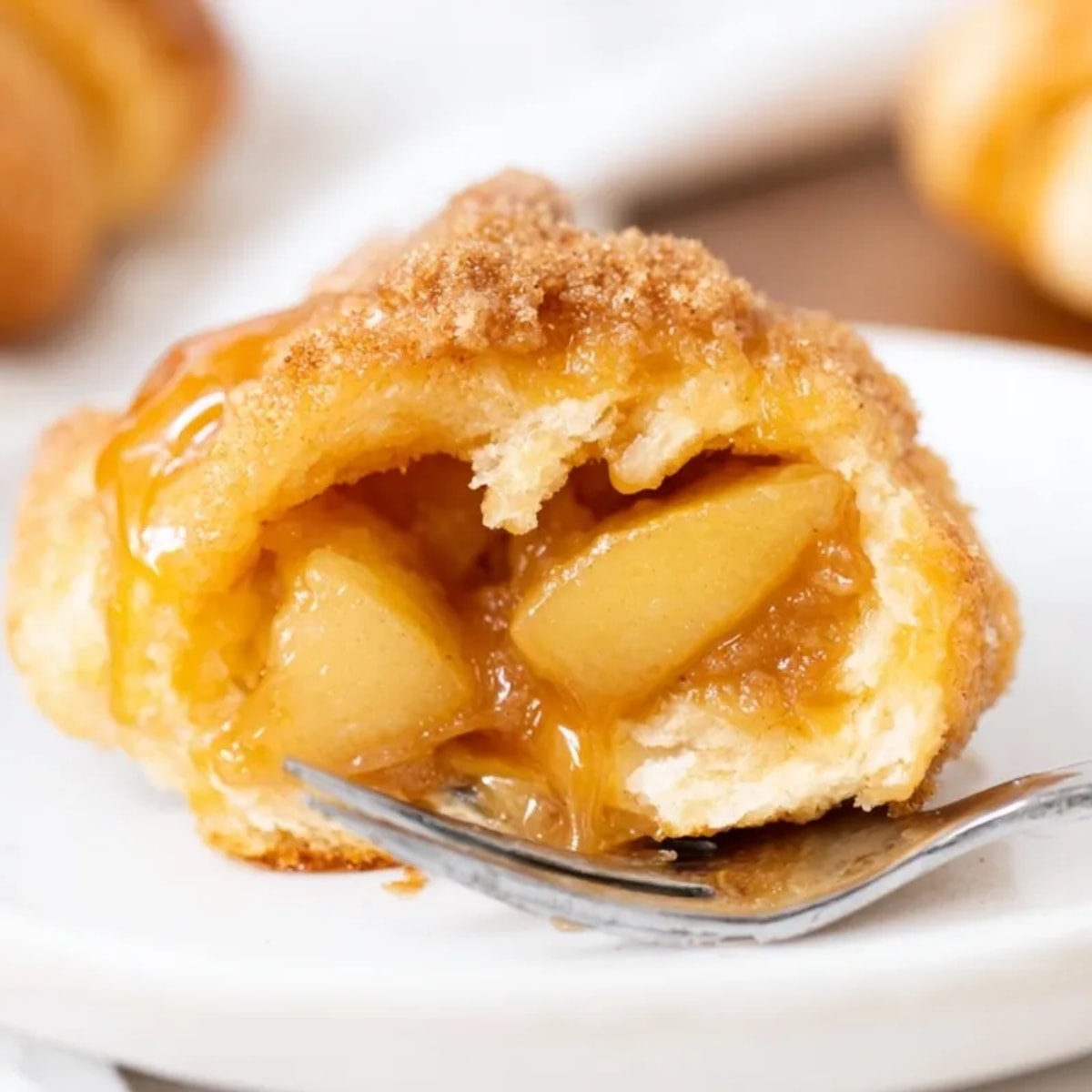 Golden brown Caramel Apple Crescent Bites, warm from the oven, topped with cinnamon-sugar.