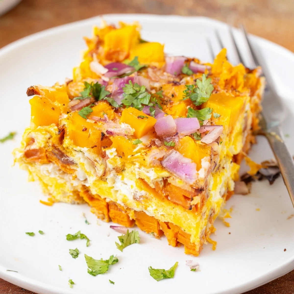 A colorful Mango Sweet Potato Egg Bake topped with fresh cilantro, perfect for brunch.  