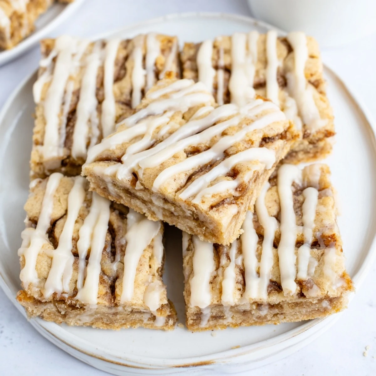 Deliciously chewy bars filled with cinnamon-sugar swirls, drizzled with vanilla glaze.  