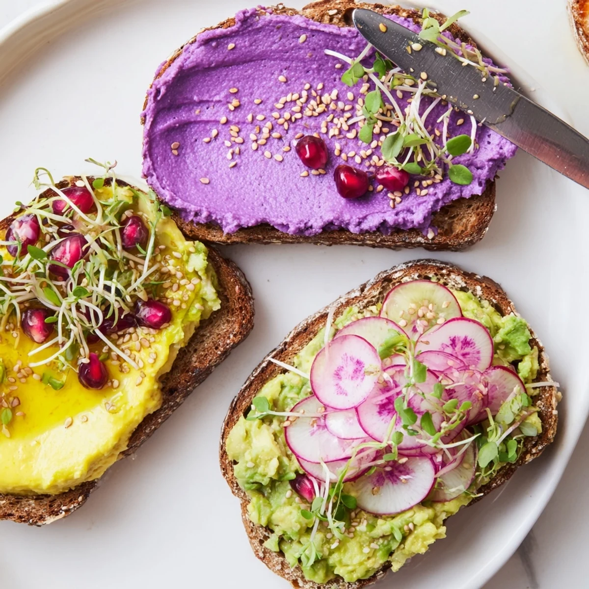 Vibrant Bright & Bold Breakfast Toasts topped with ube spread, fresh avocado, and colorful garnishes.  