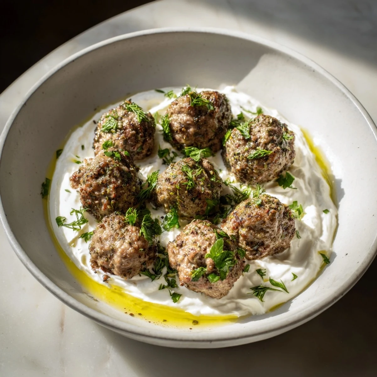 Close-up of savory Garlic Herb Lamb Meatballs, expertly fried, ready to be enjoyed.