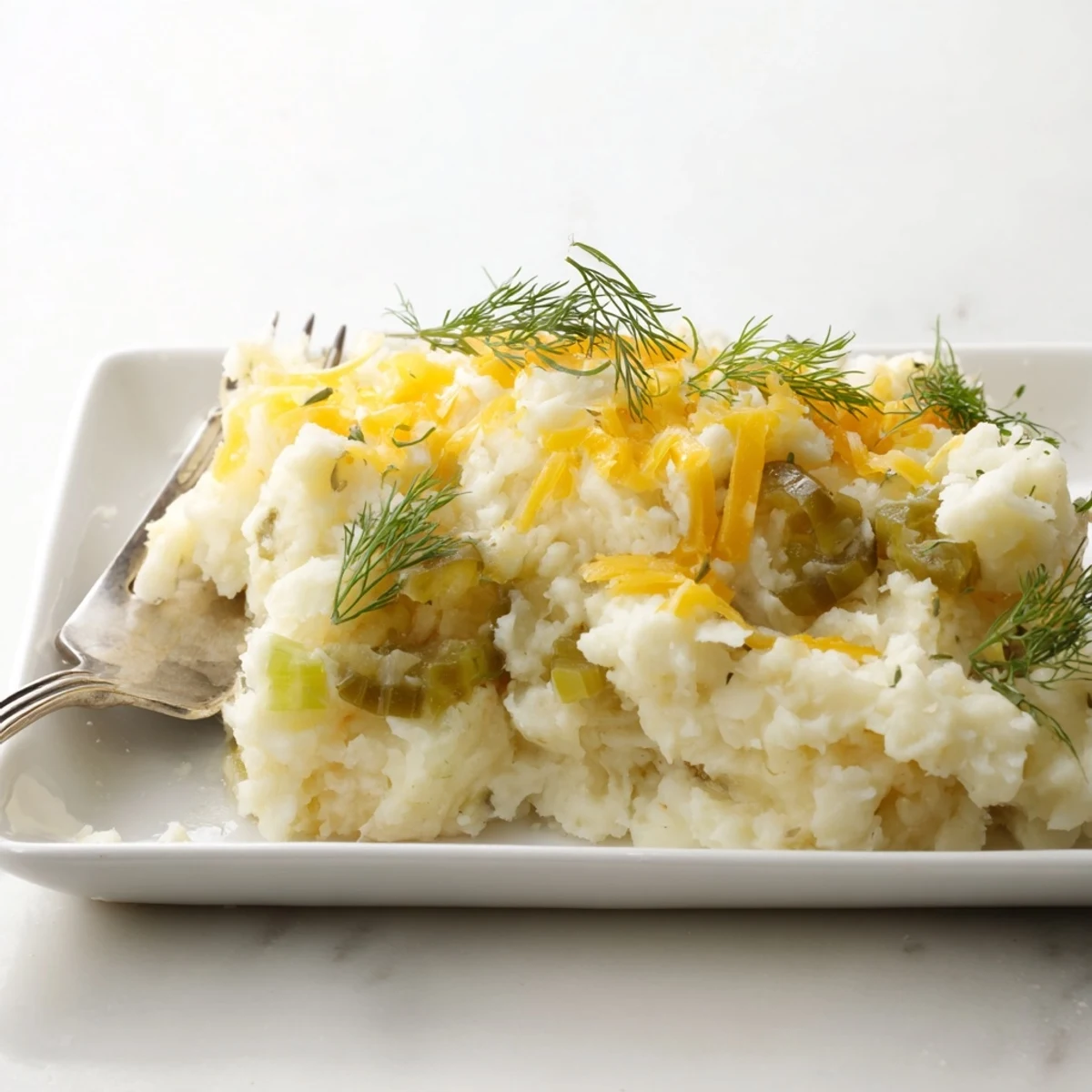 Golden, bubbly Dill Pickle Mashed Potato Bake, a comforting casserole with creamy texture and tangy pickles.