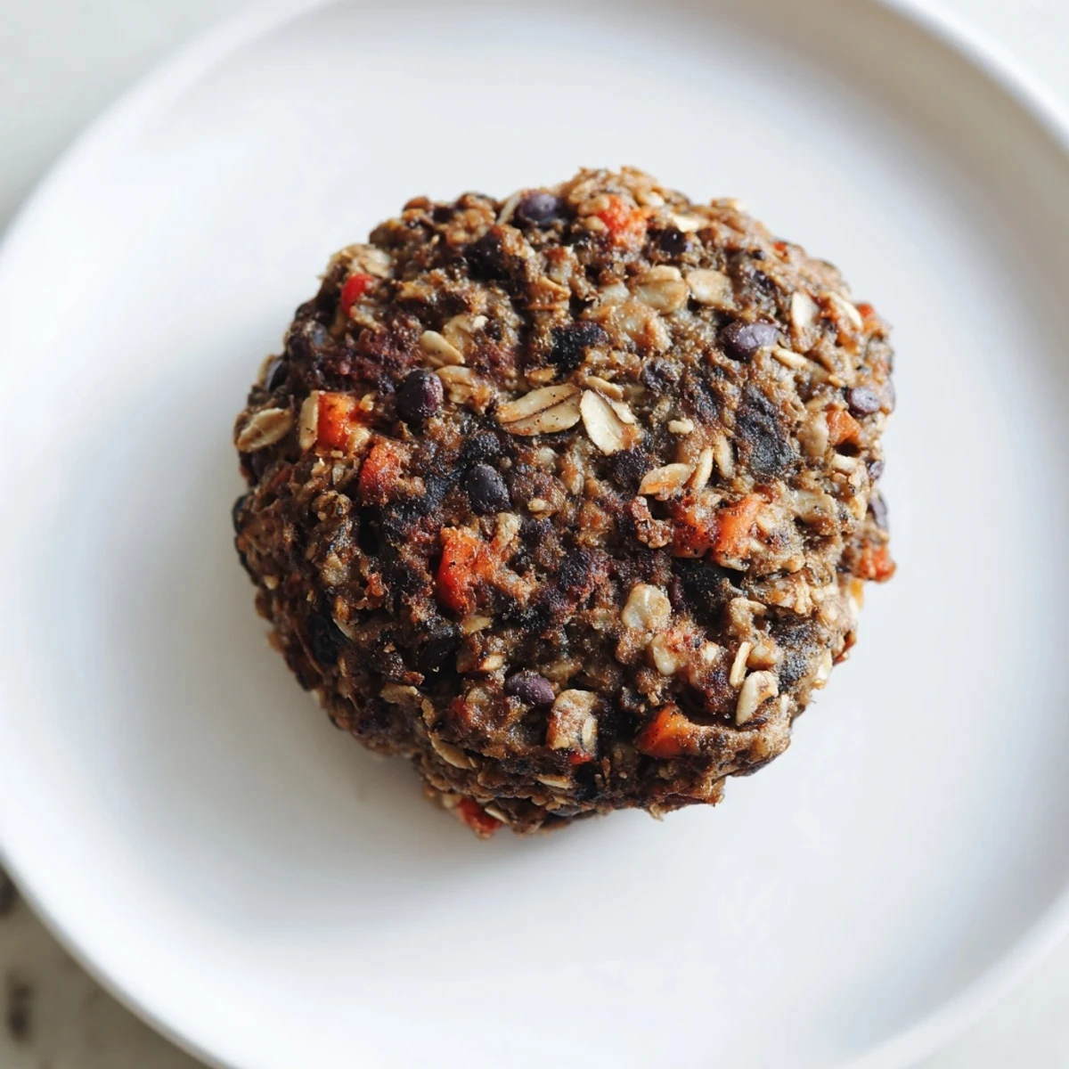 A hearty, freshly cooked black bean burger, smelling of smoky paprika and warm spices.