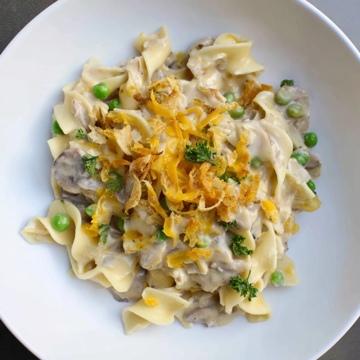 Delicious, warm Tuna Noodle Casserole with visible textures and a savory, bubbling cheese sauce.