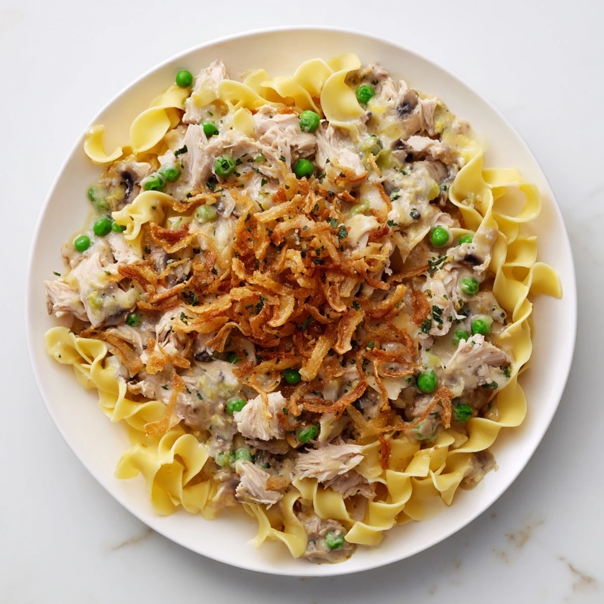 Tender egg noodles and flaky tuna baked in a creamy sauce, a classic tuna noodle casserole delight.
