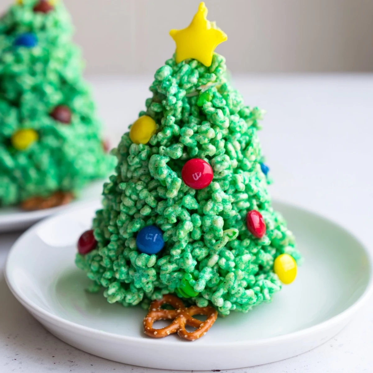Festive Christmas Tree Rice Crispy Treats, bright green and drizzled with colorful candies, perfect for holiday joy.