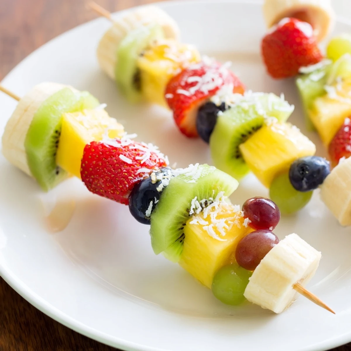 Easy festive fruit kabobs presentation: Vivid display of juicy, arranged fruit, perfect for a picnic platter.