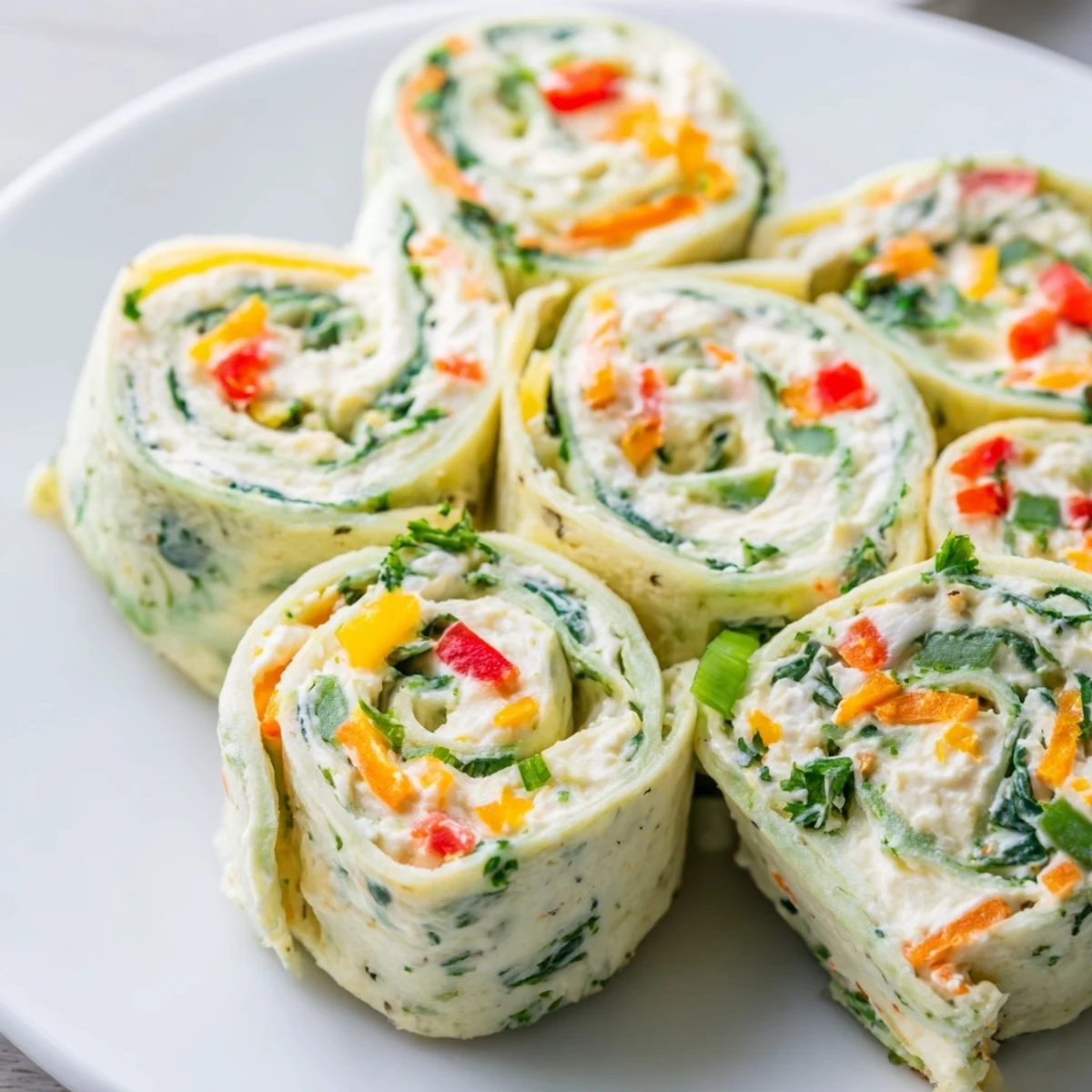 Delicious, colorful Cozy Scarf Holiday Pinwheel Wraps; sliced, ready to serve at a holiday party.