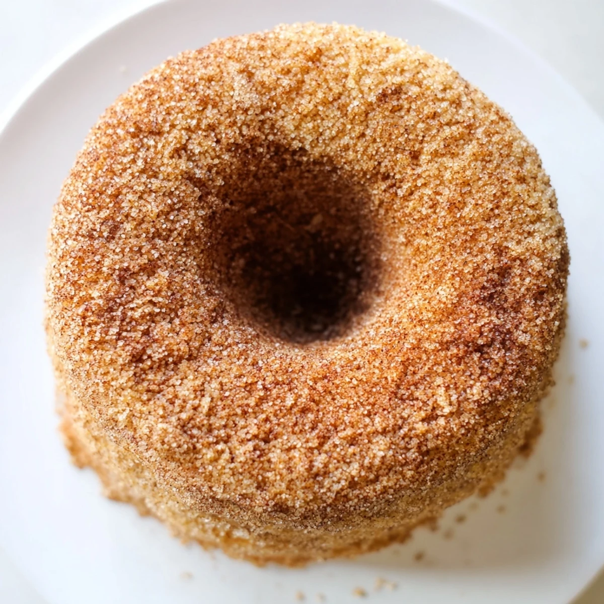 Warm cinnamon-sugar baked donuts, a classic American dessert, perfect for breakfast or a sweet snack.