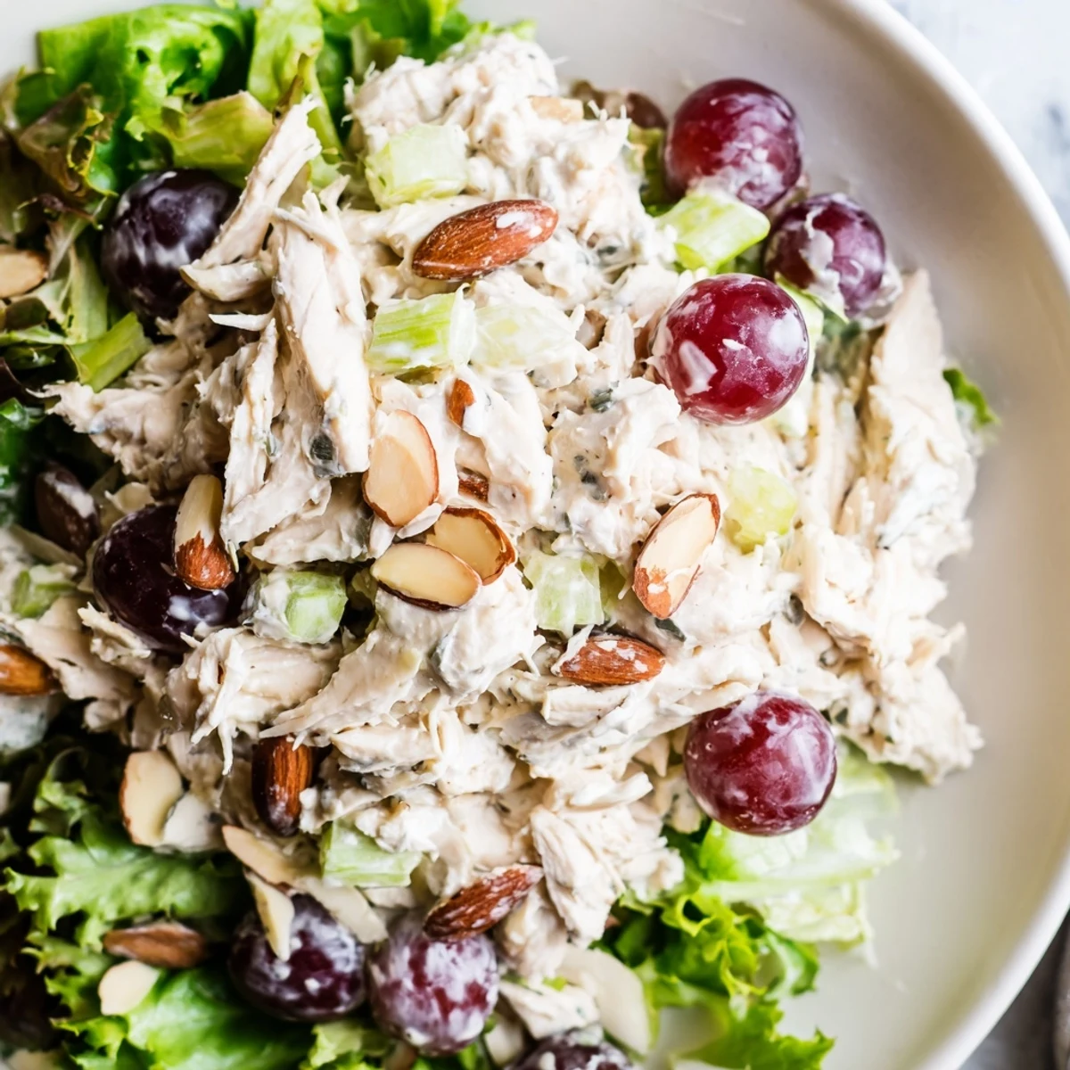 Creamy Crispy Chicken Salad with juicy grapes, a perfect American lunch, ready on fresh greens.