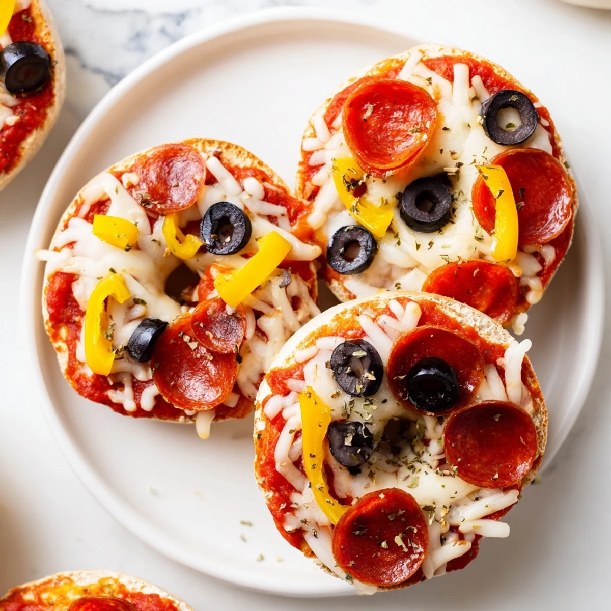 Golden, melted mozzarella blankets mini bagel pizzas with hints of oregano and savory pepperoni.