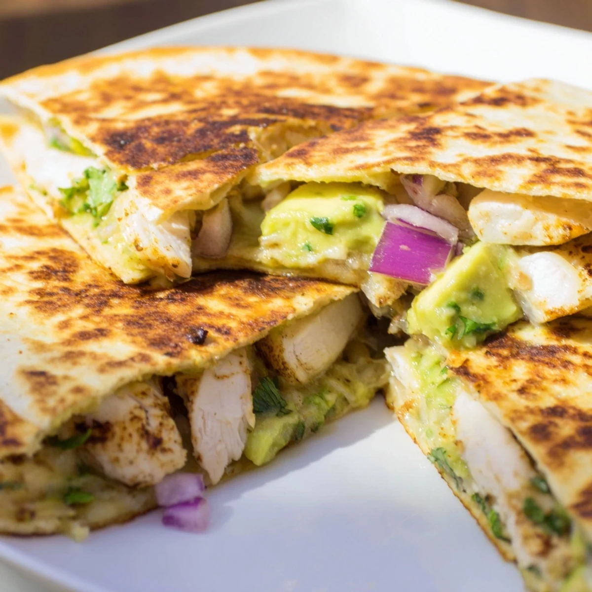 Golden, cheesy Chicken Avocado Quesadilla halves, filled with tender chicken and creamy avocado.