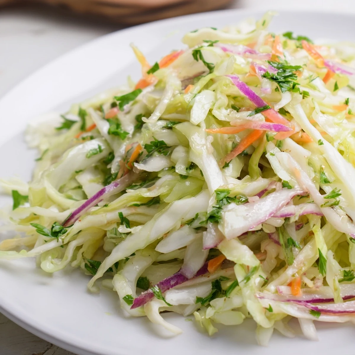 Steaming warm Cooked and Loved Cabbage Salad showcases tender sautéed cabbage, colorful bell peppers, and fresh parsley, served in a rustic bowl ready to enjoy.  