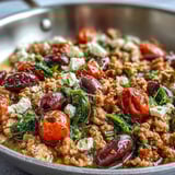 Juicy ground chicken, briny Kalamata olives, and sweet cherry tomatoes fill this Mediterranean Keto Ground Chicken Skillet, topped with creamy feta crumbles.