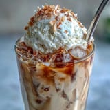 Tropical cold brew coffee float, a sweet, icy dessert beverage delight.