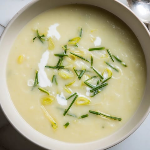 Creamy Potato & Leek Soup served in a rustic bowl, garnished with fresh chives.  