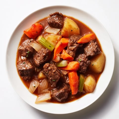 Comfort Crockpot Beef Stew simmering in a slow cooker, featuring tender vegetables and rich broth.