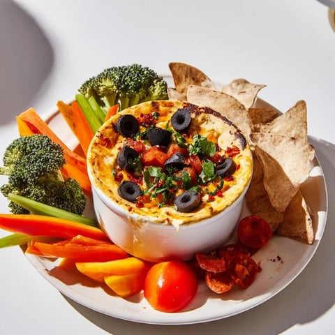 A sizzling Lava Flow Volcano Dip platter with melty cheese and colorful veggies ready to scoop.