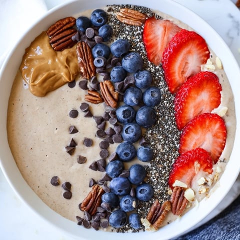 Creamy Protein Ice Cream Bowl, swirled with fresh berries, looks cool and refreshing for a treat.