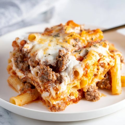 Creamy Baked Ziti with Meat Sauce topped with gooey melted mozzarella and fresh parsley.  