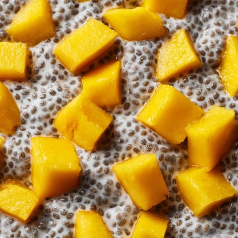 A close up of a chia seed pudding with mango.