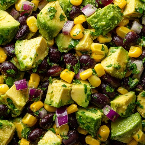 A close up of a salad with various vegetables.