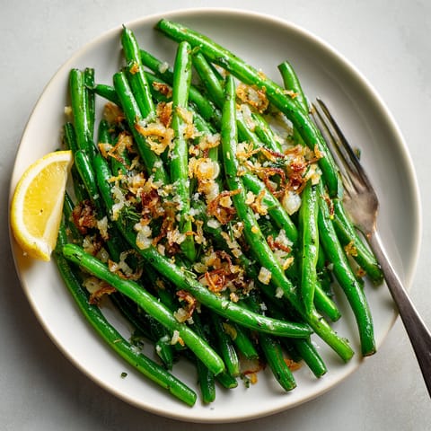 A plate of green beans with bacon and lemon.