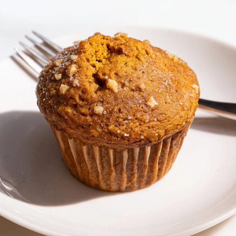Fluffy Ginger-Spiced Pumpkin Muffins, fresh from the oven, ready for a cozy breakfast.