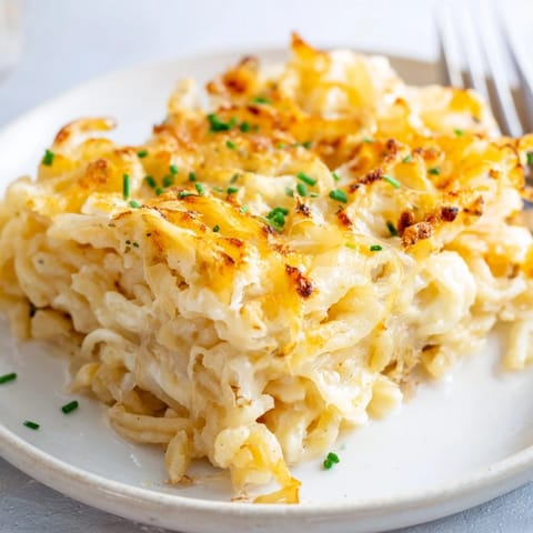 Comforting Cheesy Spaetzle Bake, rich with caramelized onions and fresh herbs.  
