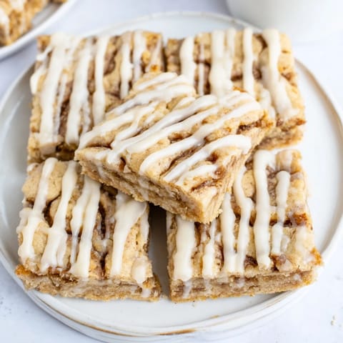 Deliciously chewy bars filled with cinnamon-sugar swirls, drizzled with vanilla glaze.  