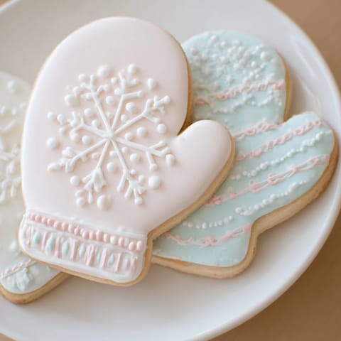 Warm & toasty mitten cookies display, perfect for winter, featuring beautifully frosted, colorful sugar cookies.