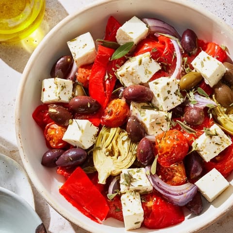 A colorful Black Olive and Sun-Dried Tomato Platter, drizzled with olive oil and bursting with Mediterranean flavors.