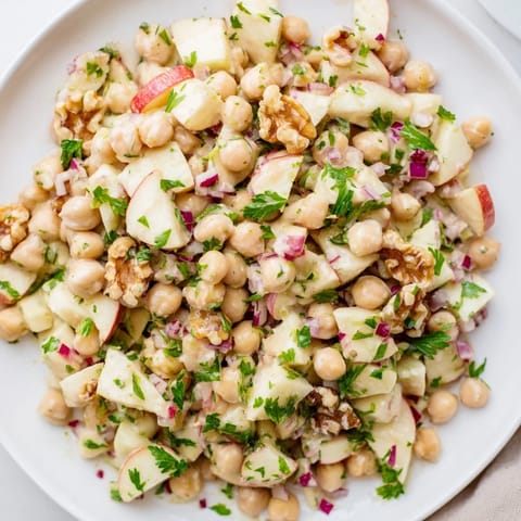 Freshly tossed Fall Harvest Apple and Chickpea Salad with a tangy honey-mustard dressing looks delicious.
