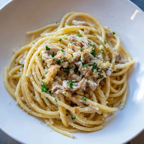 Golden-brown Simple Garlic Butter Bucatini with shredded chicken, a quick and satisfying dinner.