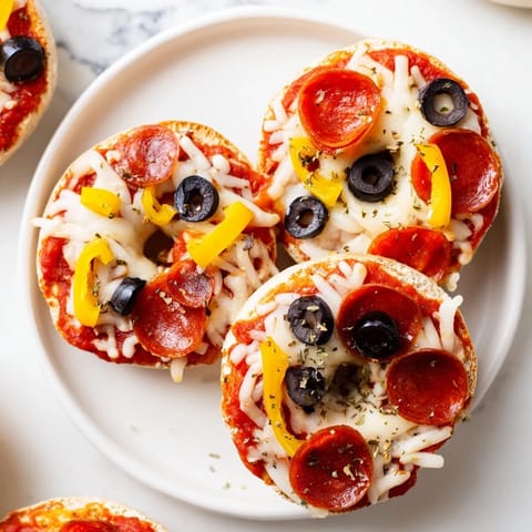 Golden, melted mozzarella blankets mini bagel pizzas with hints of oregano and savory pepperoni.