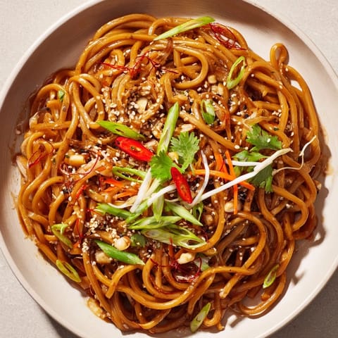Close-up of glossy, seasoned Asian Garlic Noodle Bowl, perfect for a quick & easy weeknight dinner.