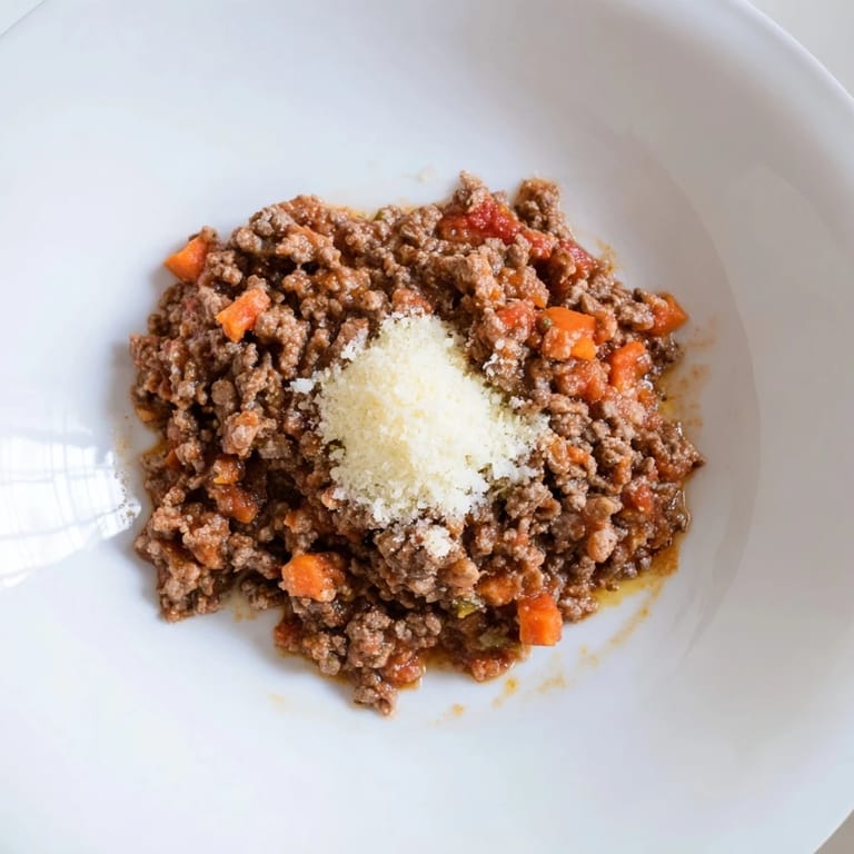 A close-up of steaming Classic Tuscan Ragu, showcasing the hearty textures and savory aromas.