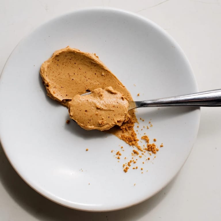 Golden, shimmering Quick Christmas Cookie Butter Spread, enticingly smooth and perfect for dipping apples.