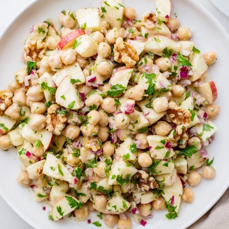 Freshly tossed Fall Harvest Apple and Chickpea Salad with a tangy honey-mustard dressing looks delicious.