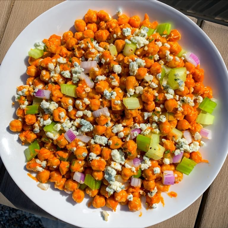 This colorful buffalo chicken bean salad offers a creamy, satisfying crunch from fresh vegetables and chickpeas.