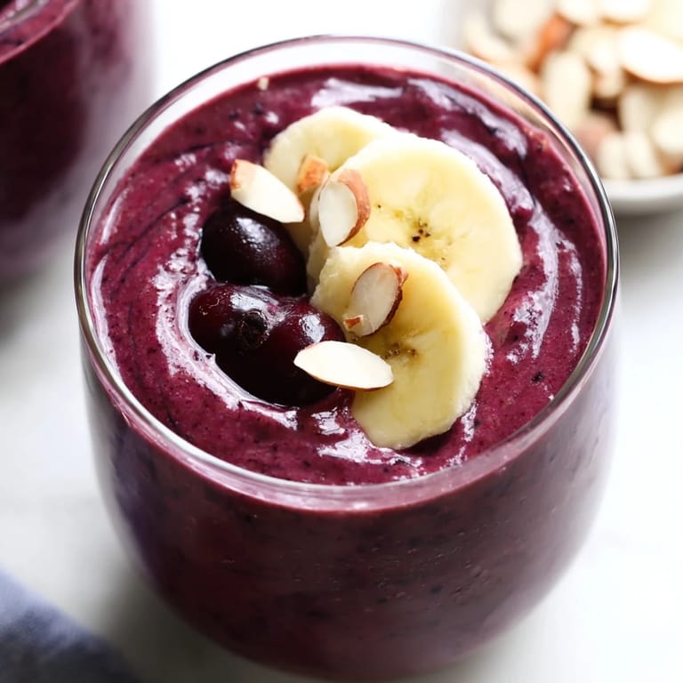 Blending frozen tart cherries and almond butter creates a luscious Cherry Almond Smoothie, an ideal cooling beverage for warm afternoons.