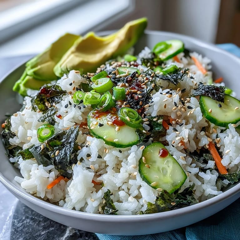 Two servings of homemade Seaweed Snack Sushi Bowl topped with cucumber, edamame, and sesame seeds, ready to eat with chopsticks.