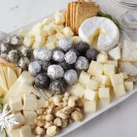 Elegant The Silver Screen cheese board, featuring truffle brie, chocolates, and grapes, perfect for movie night.